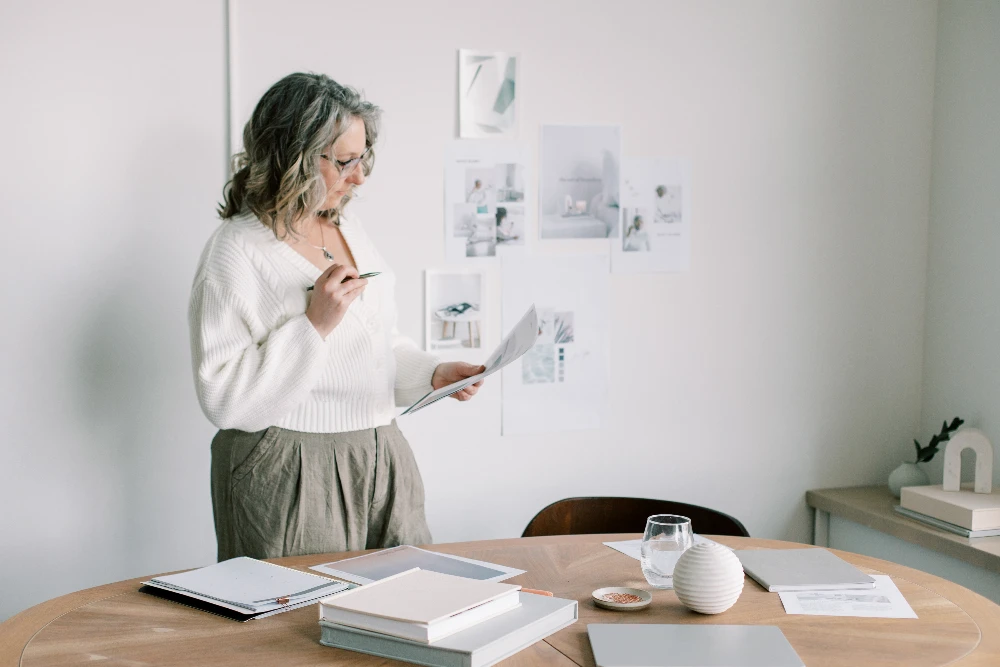 promotional image for CSRA Marketing, a local website & marketing agency based in Augusta, GA. Image shows: a woman reviewing papers in an open & airy office