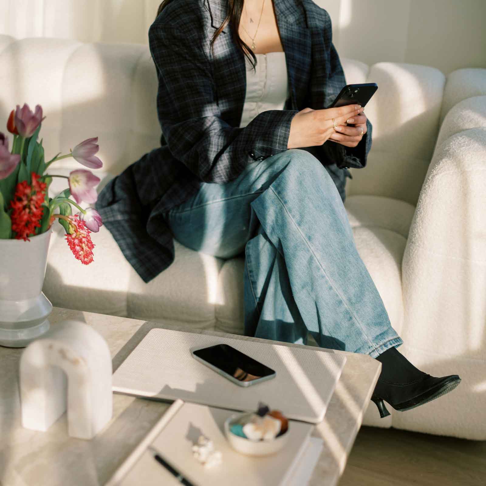 image of a woman on the couch looking for something on her smartphone - CSRA Marketing digital ad campaign setup