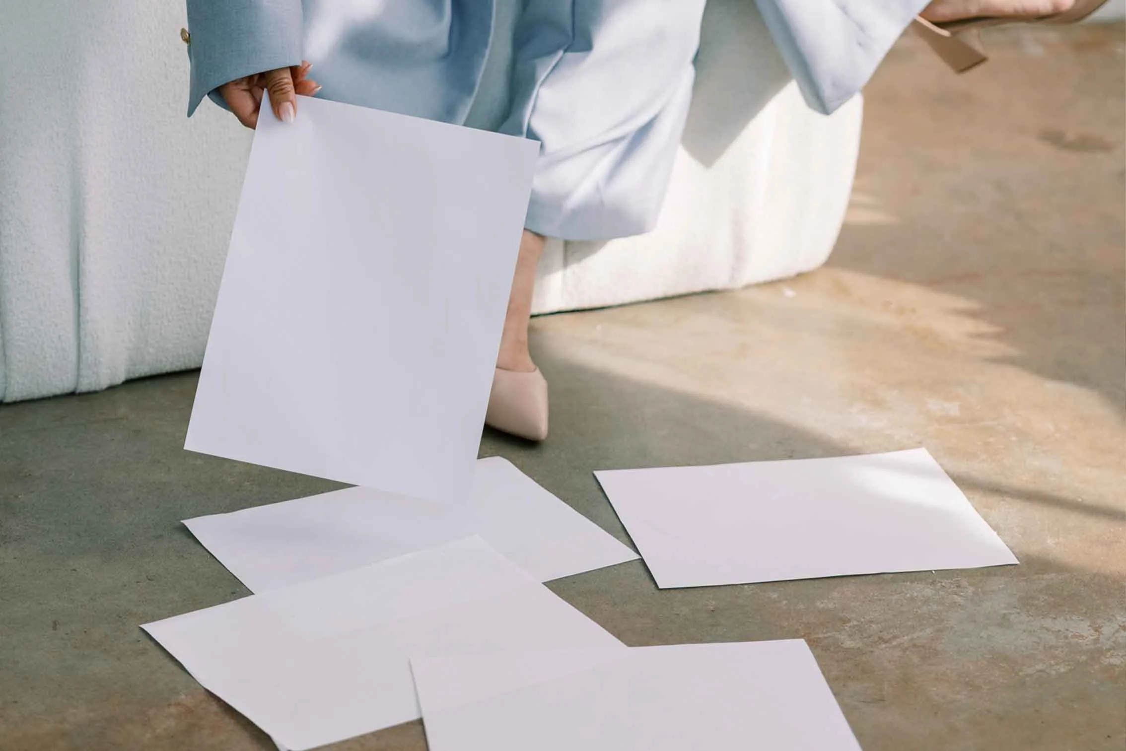 promotional image for custom design services provided by CSRA Marketing, a local service business website & amrketing agency. Image shows: papers falling onto the floor as a designer works
